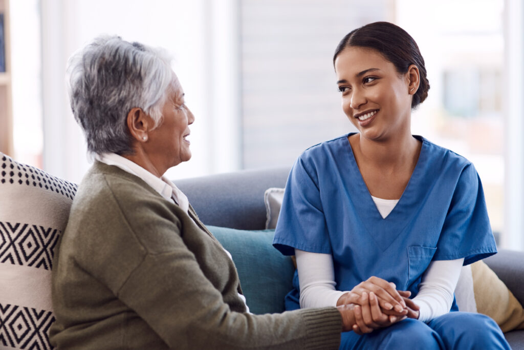 Nurse comforting older woman