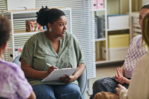 Psychologist leading group therapy session