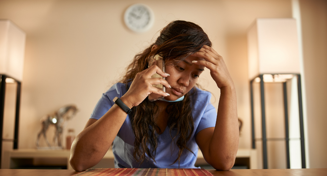 Worried nurse on phone