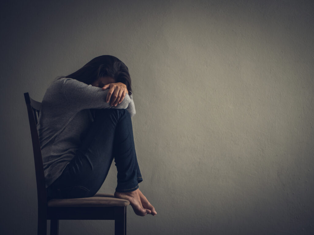 depressed woman on chair