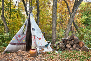 Tepee in the autumn forest. Indian tent exhibition.