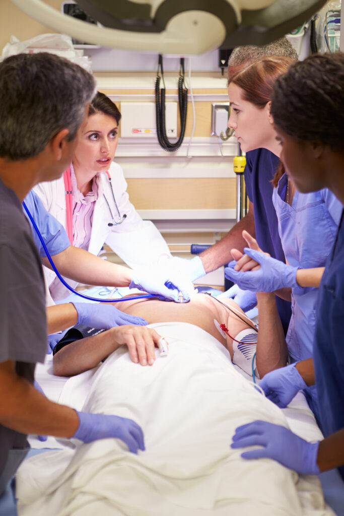 Medical Team Working On Patient In Emergency Room