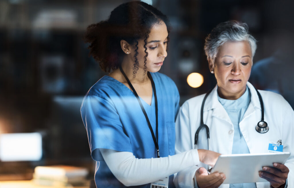 Women, doctors and tablet for night medical research, surgery planning and teamwork in hospital. Nurse, healthcare and worker collaboration on technology in late shift for wellness thinking and ideas.