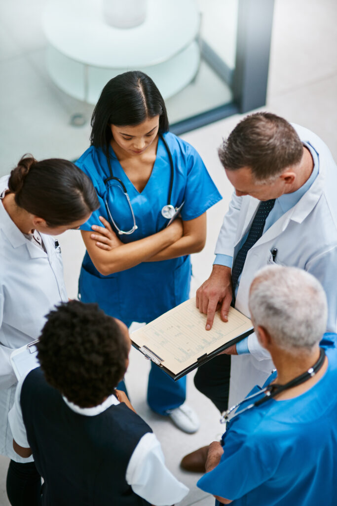 Teamwork, clipboard and medical with doctors in hospital for consulting, planning and communication. Medicine, healthcare and checklist with group of people for support, review and analysis.